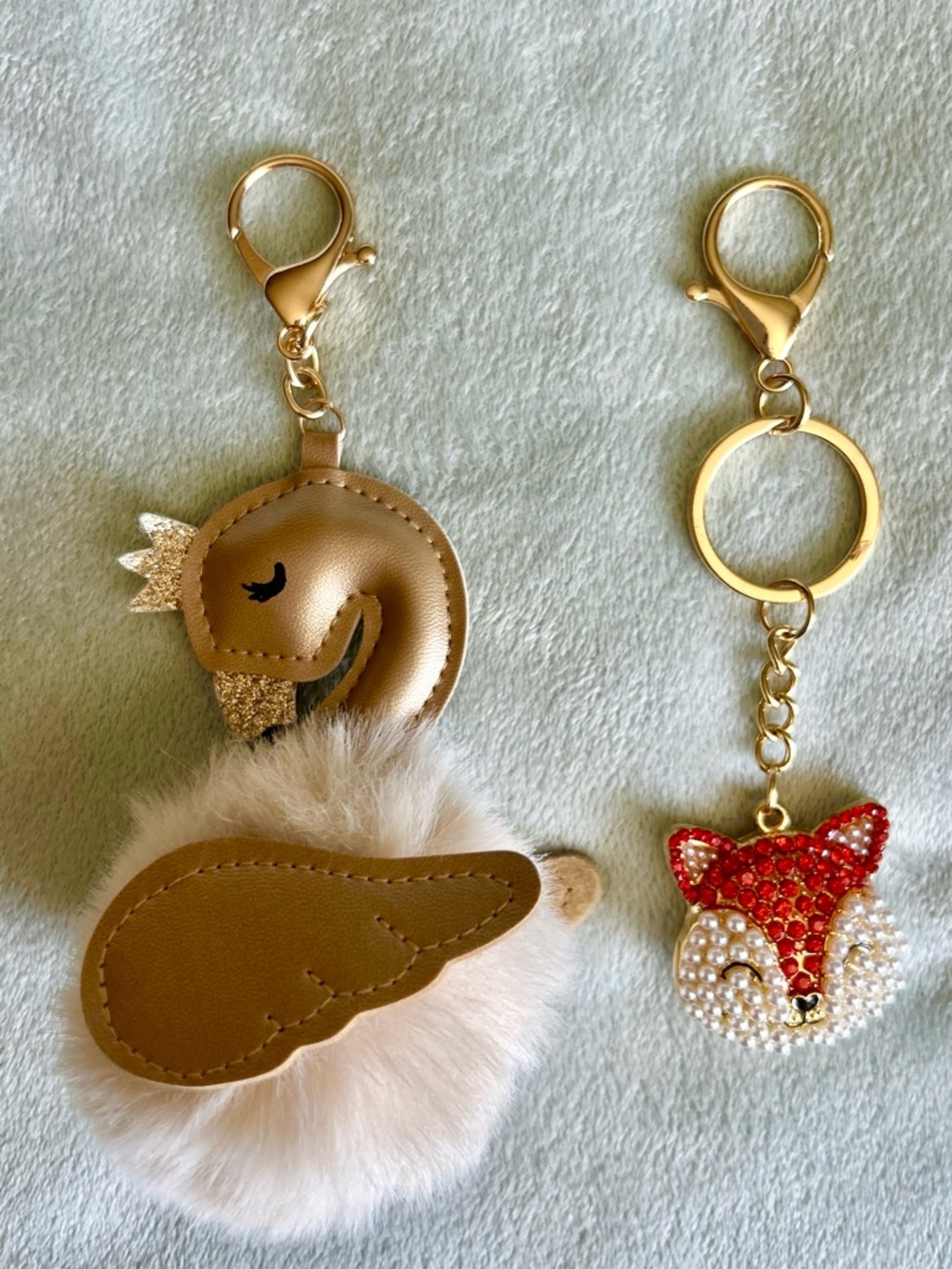 Gold Swan Pom Key Charm and Orange & White Cat Pendant Key Chain Duo